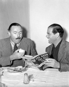 Ernest Hemingway Sitting With Frank Capra Holding Fruit